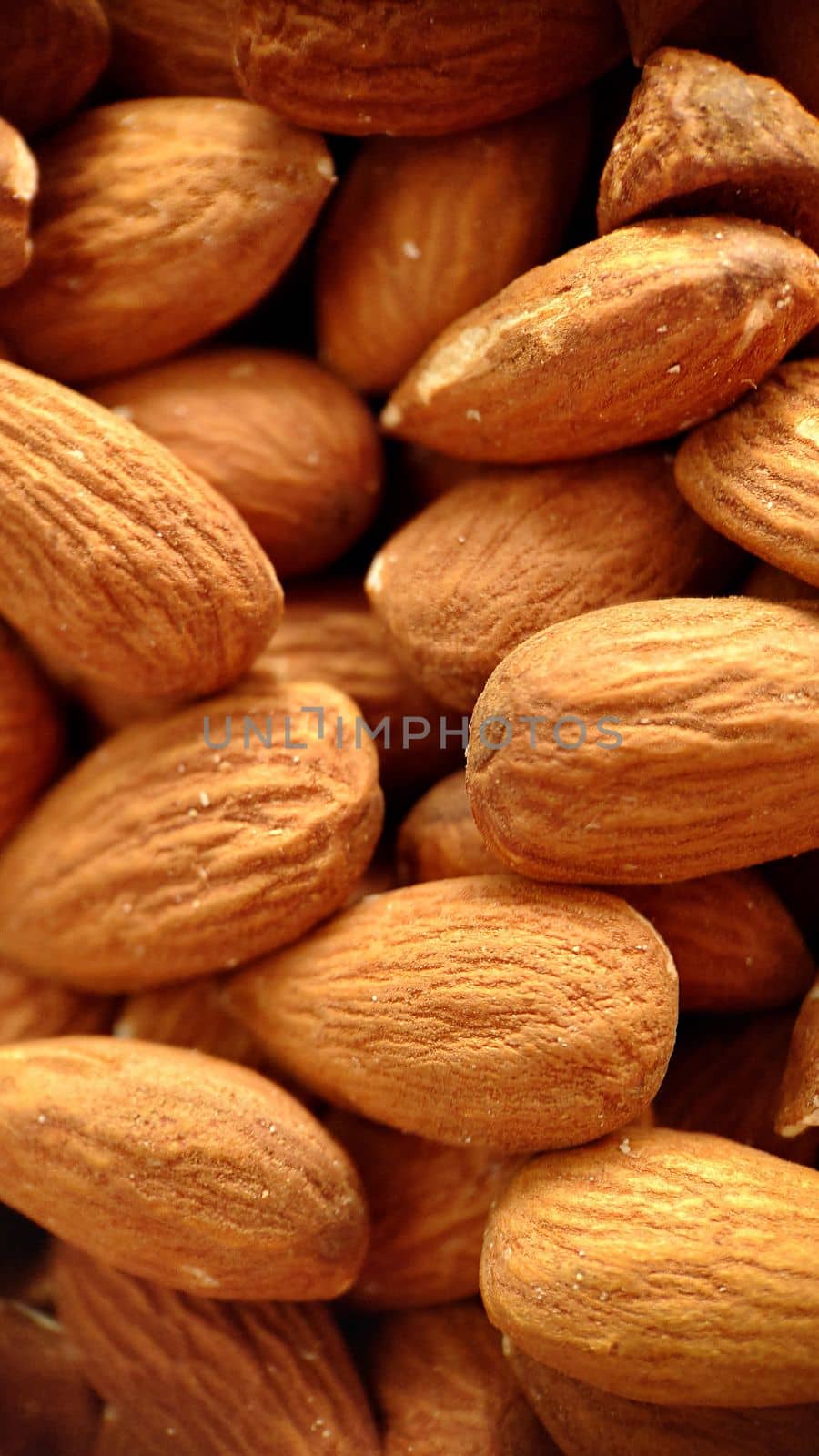 A close-up background image of almonds with selective focusing.Macrophotography.Texture or background. Selective focus.