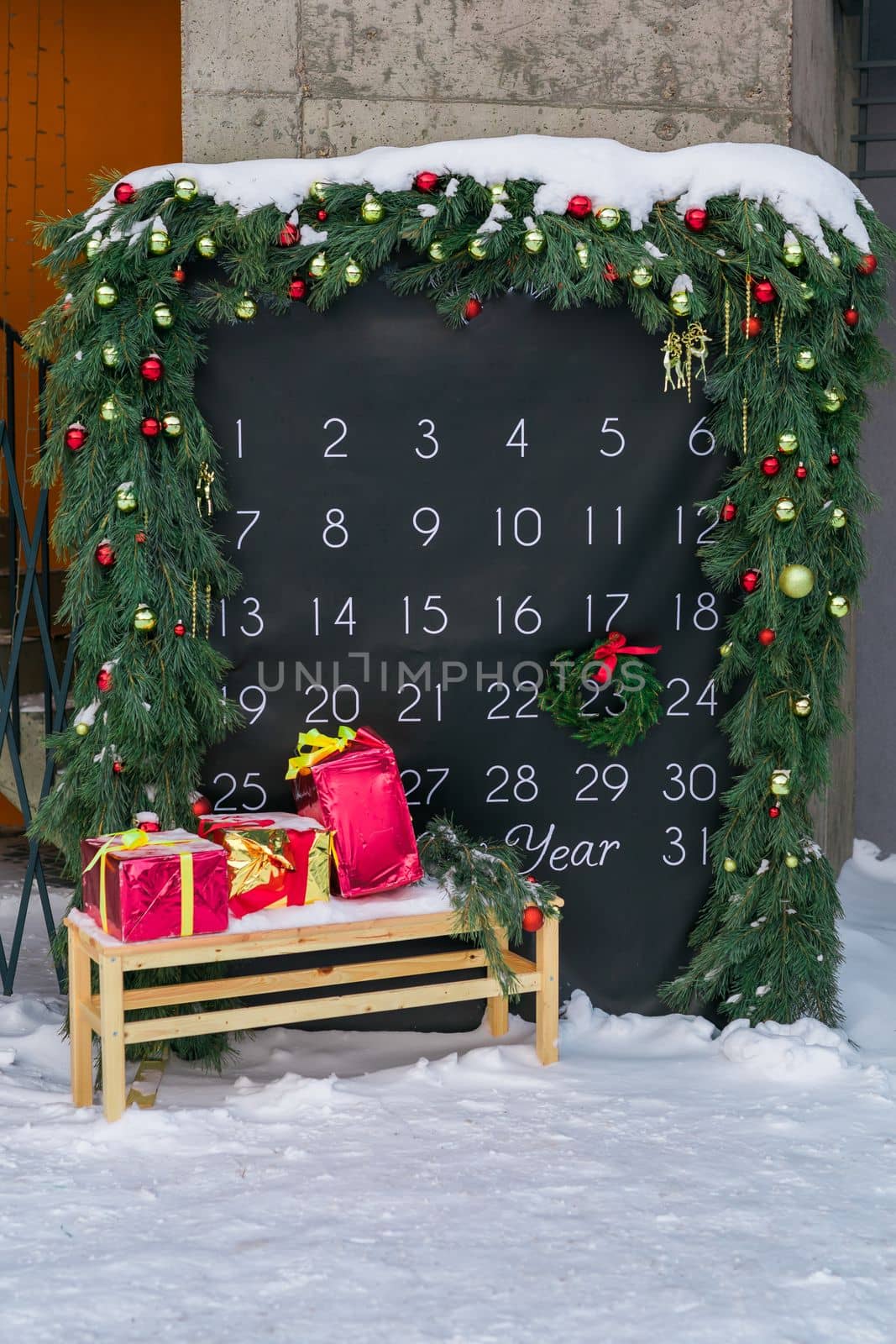 Simple desk advent calendar for December 2022 in city park with Christmas decorations by Satura86