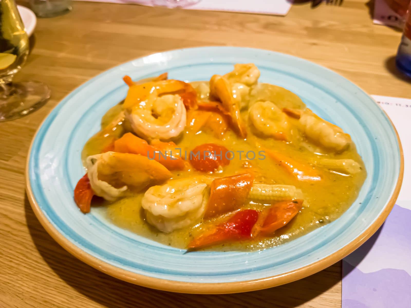 Indian spicy food shrimp curry prepared with coconut served as side dish by Milanchikov