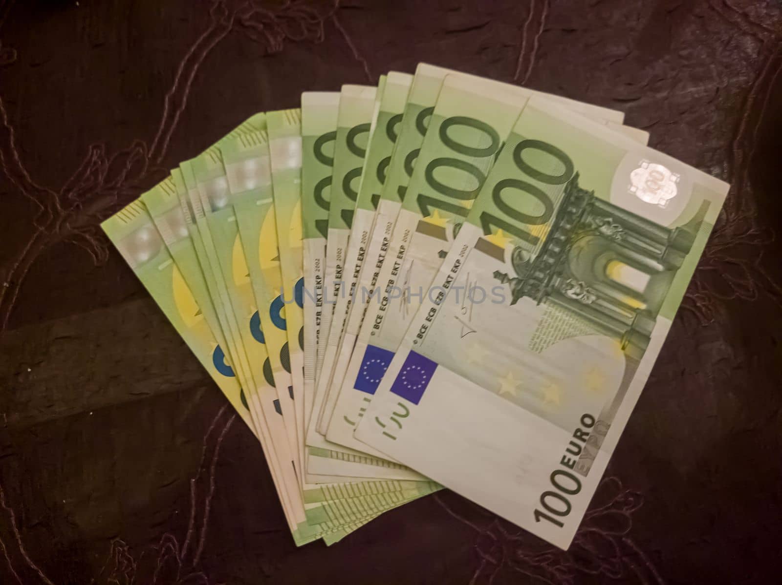 100 euro banknotes on pink background.Business, finance.
