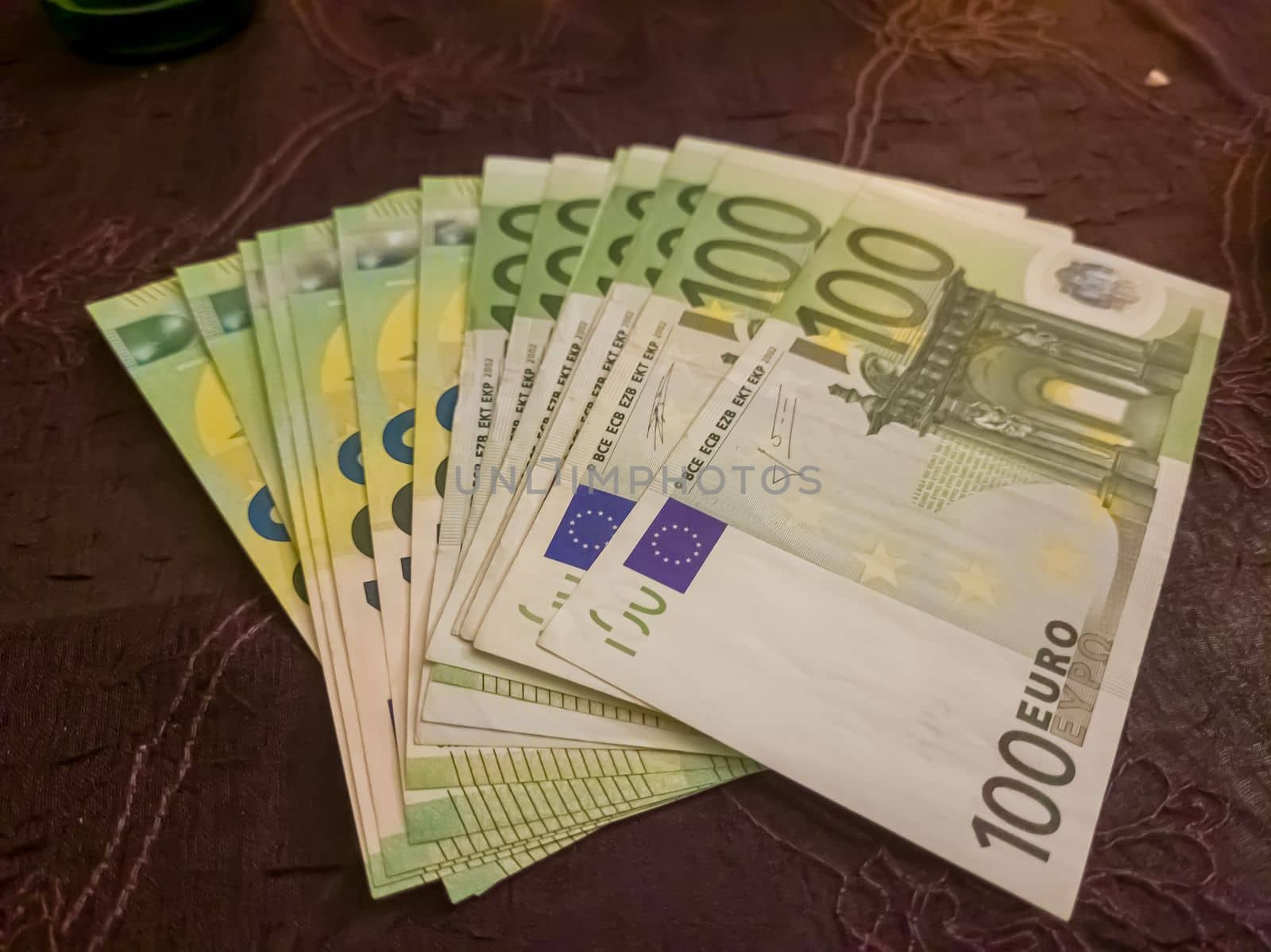 100 euro banknotes on pink background.Business, finance.
