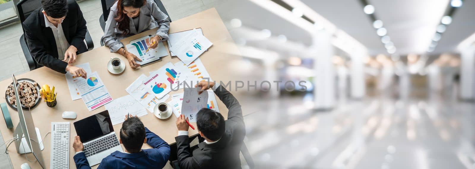 Business people group meeting shot from top widen view in office . Profession businesswomen, businessmen and office workers working in team conference with project planning document on meeting table .