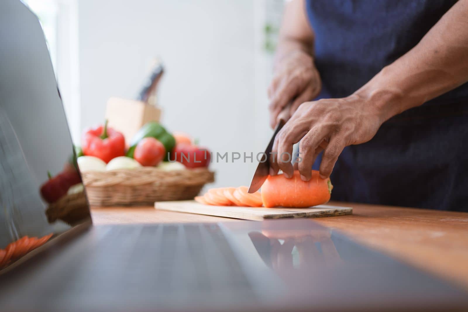 Portrait of asian man making salad at home. cooking food and Lifestyle moment by itchaznong