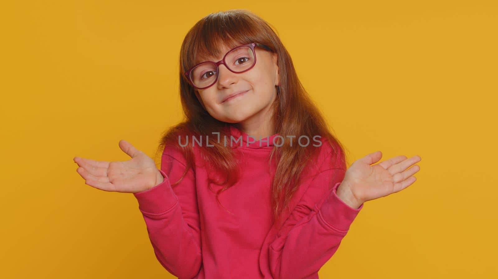 I dont know what to say. Confused young toddler school girl feeling embarrassed about ambiguous question having doubts no idea, being clueless and uncertain. Teen female child kid on yellow background