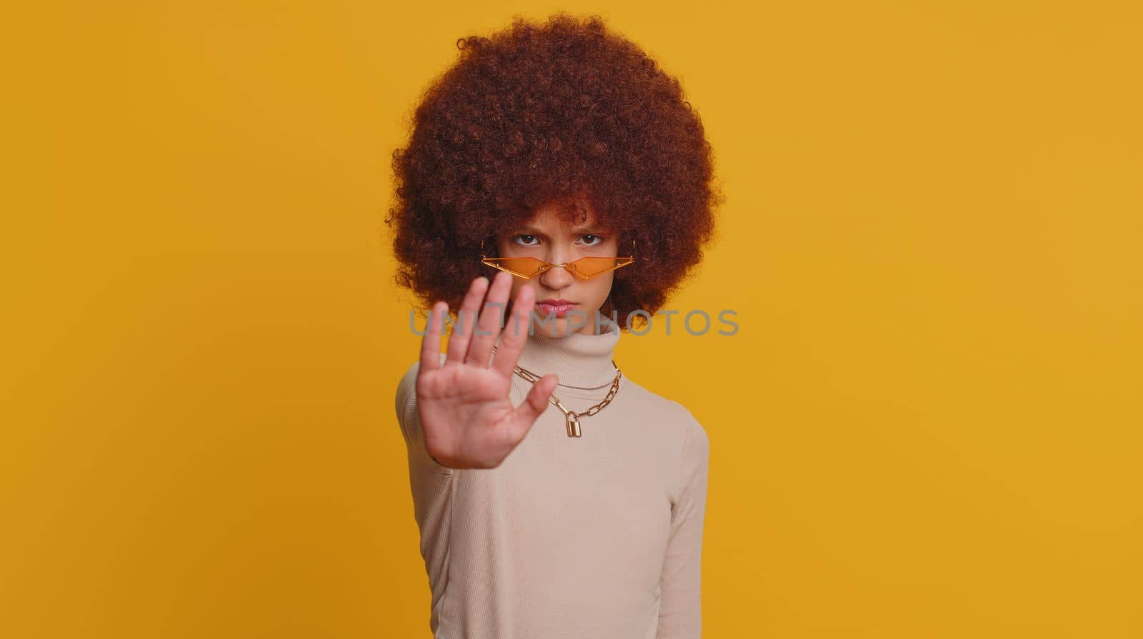 Stop gesture. Angry young teenager child girl kid say No hold palm folded crossed hands, warning of finish, prohibited access, declining communication, body language, danger. Little serious children