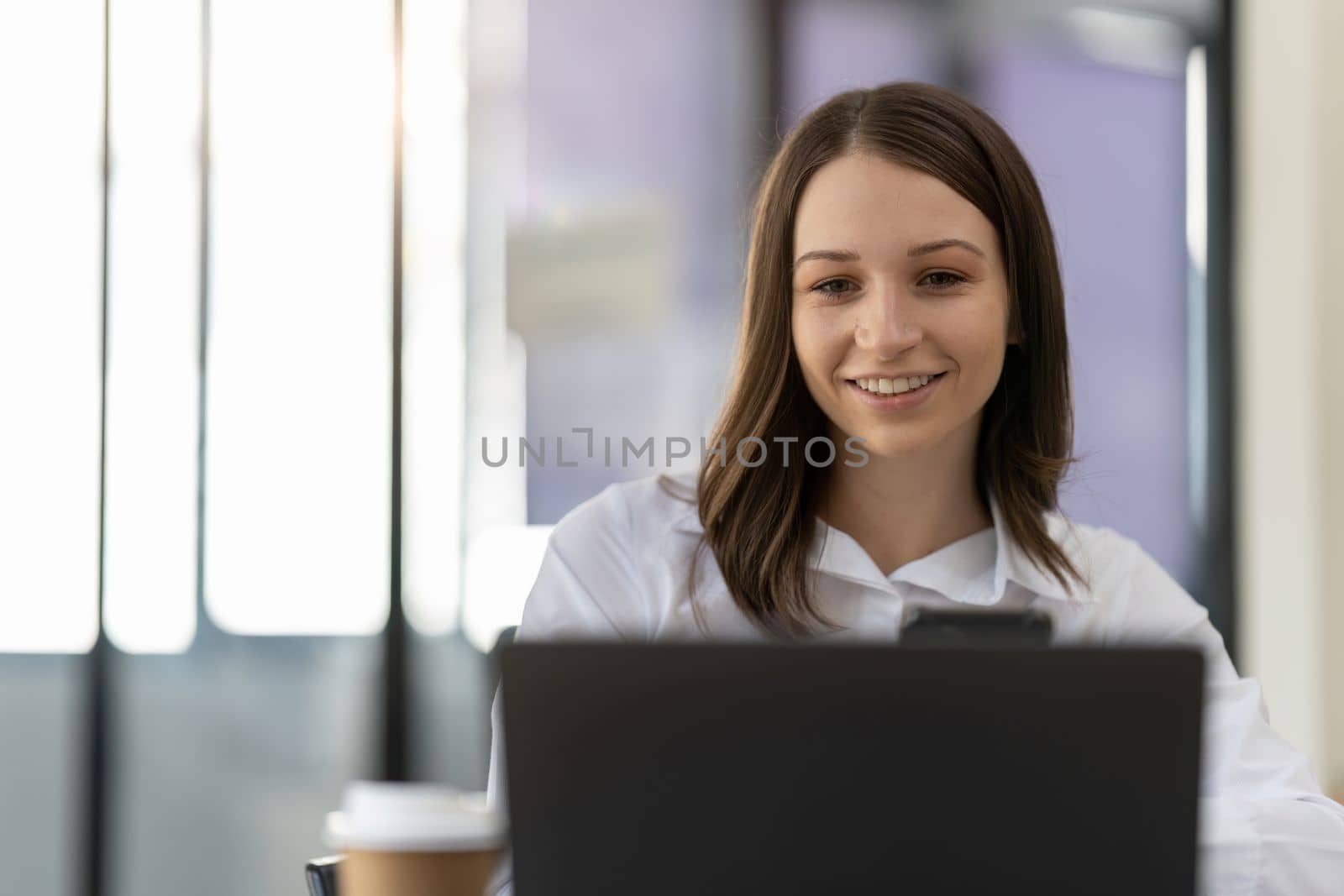 Portrait of smiling beautiful millennial businesswoman. happy female boss posing making headshot picture for company photoshoot, confident successful woman at work by nateemee