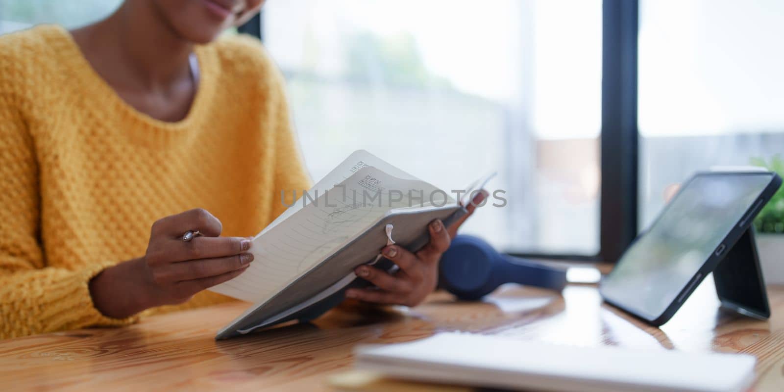 Young black curly hair American African woman using digital tablet.
