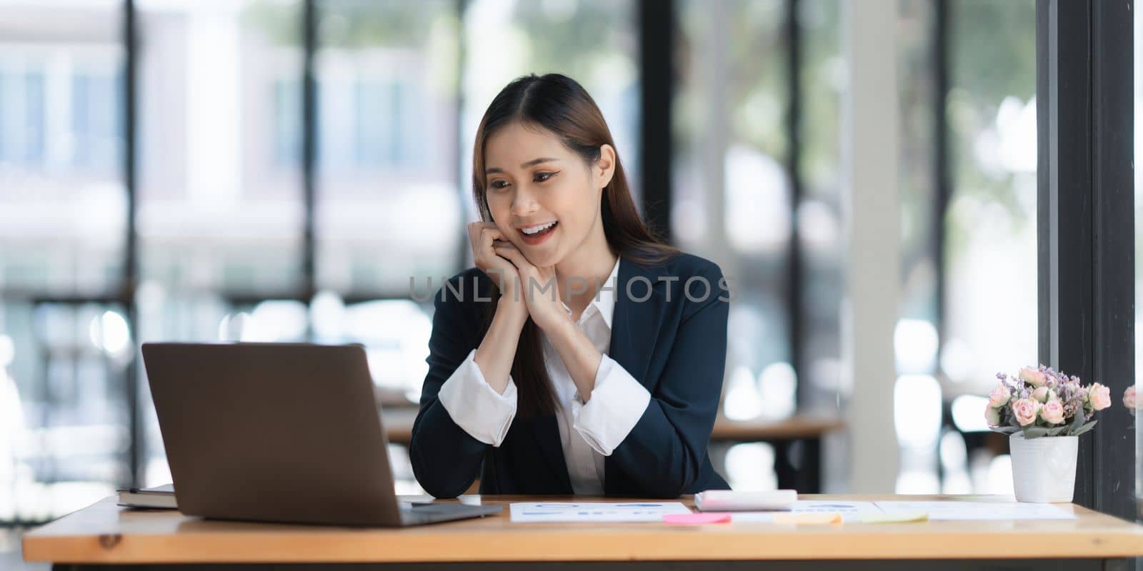 Beautiful asian businesswoman working on laptop in office. business finance concept.