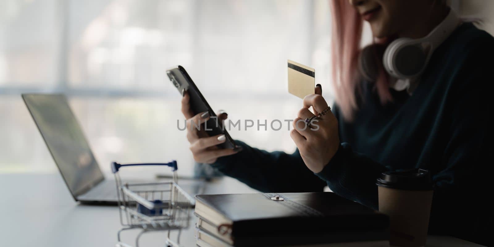 Young person using credit card and smart phone. Online shopping, e-commerce concept by itchaznong