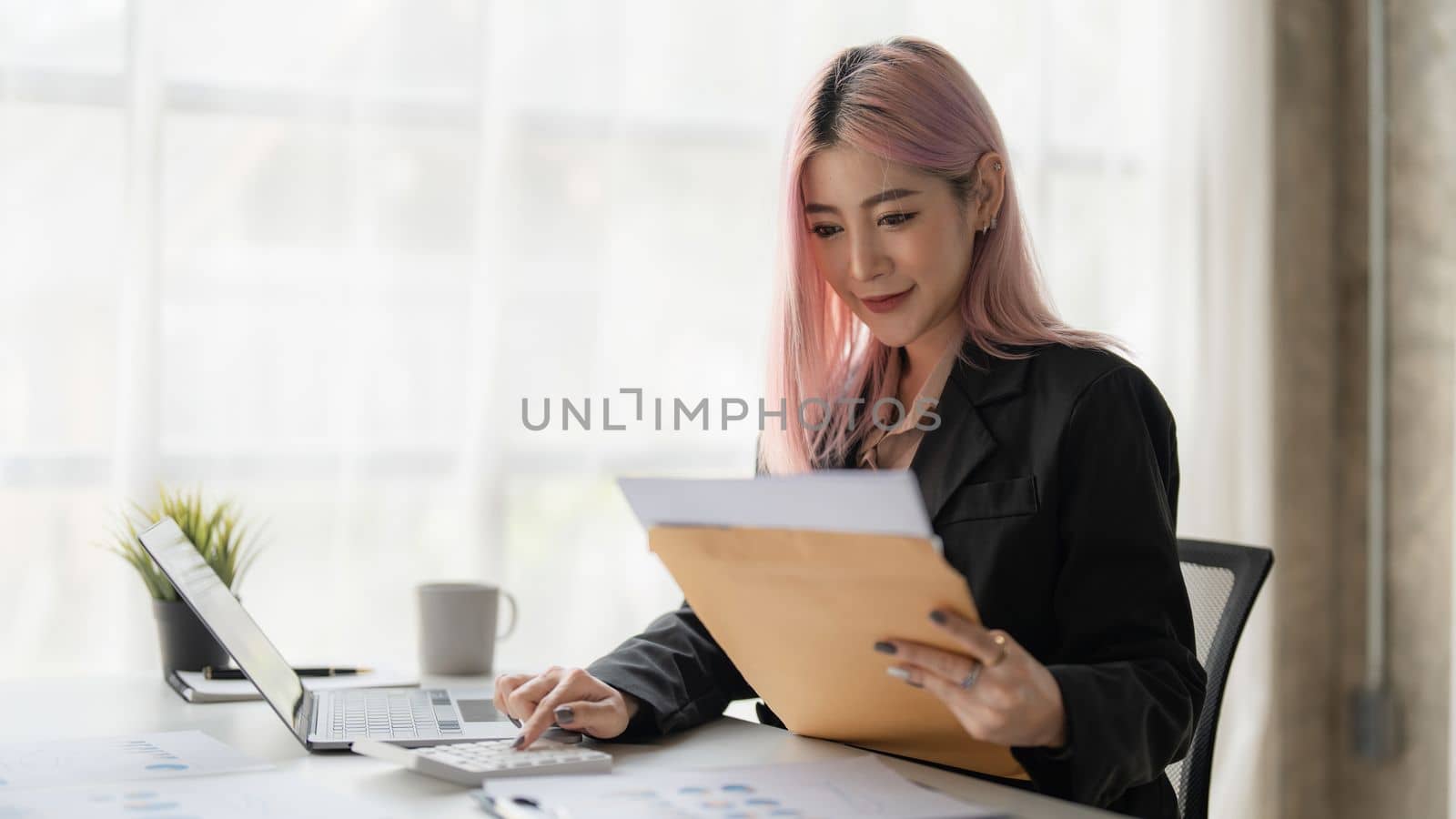 Asian Business woman working to analyze technical price graph and indicator with business team talking by cell phone. account or saving money or insurance concept by itchaznong