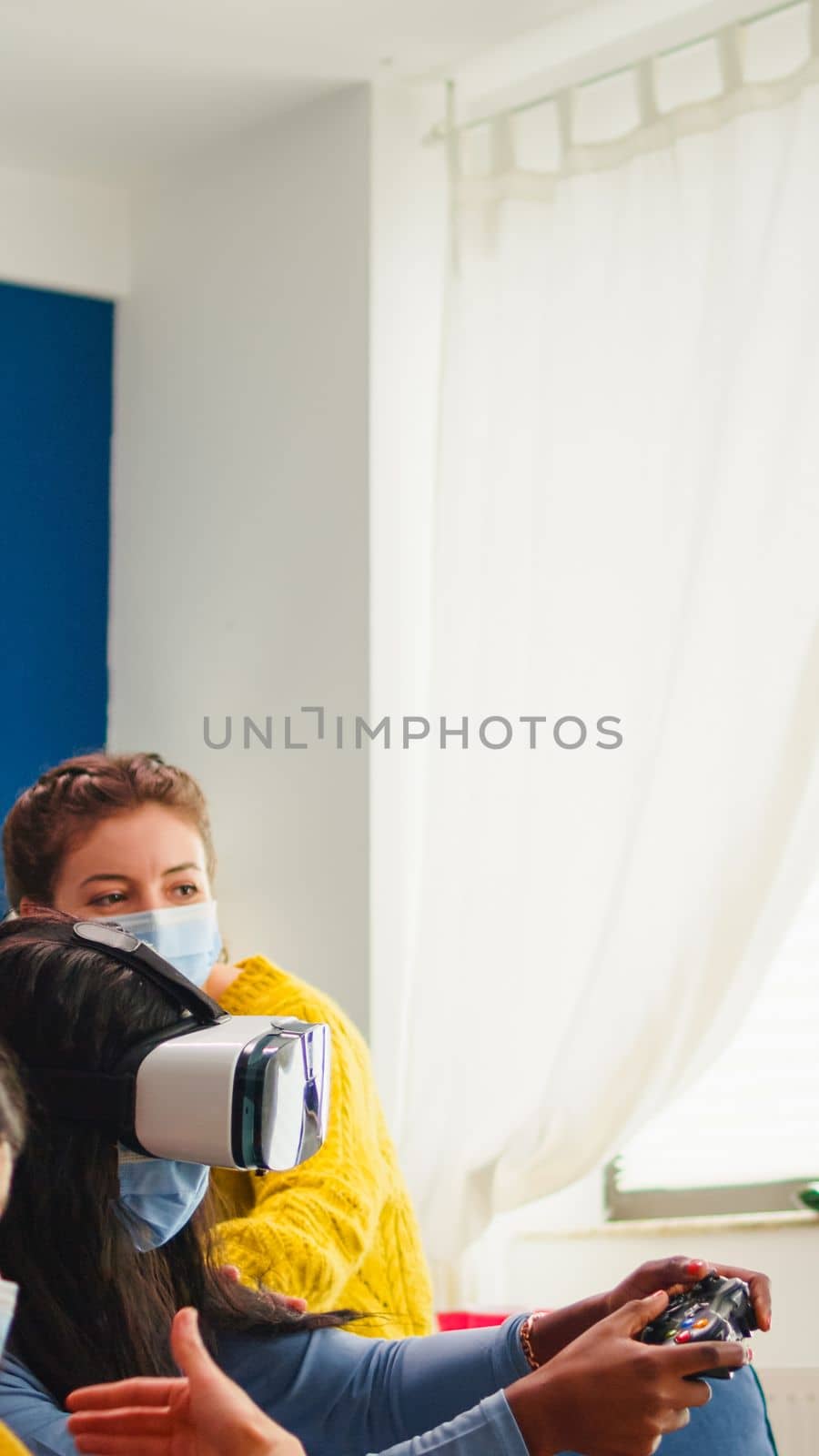 Black woman experiencing virtual reality headset playing video games by DCStudio