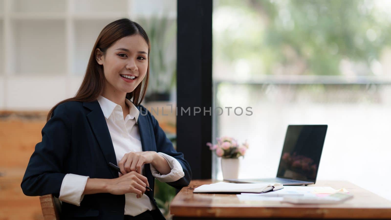 Beautiful asian businesswoman working on laptop in office. business finance concept by itchaznong