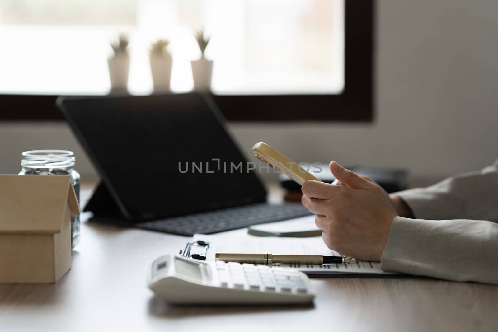 Business woman reading phone message at office by itchaznong