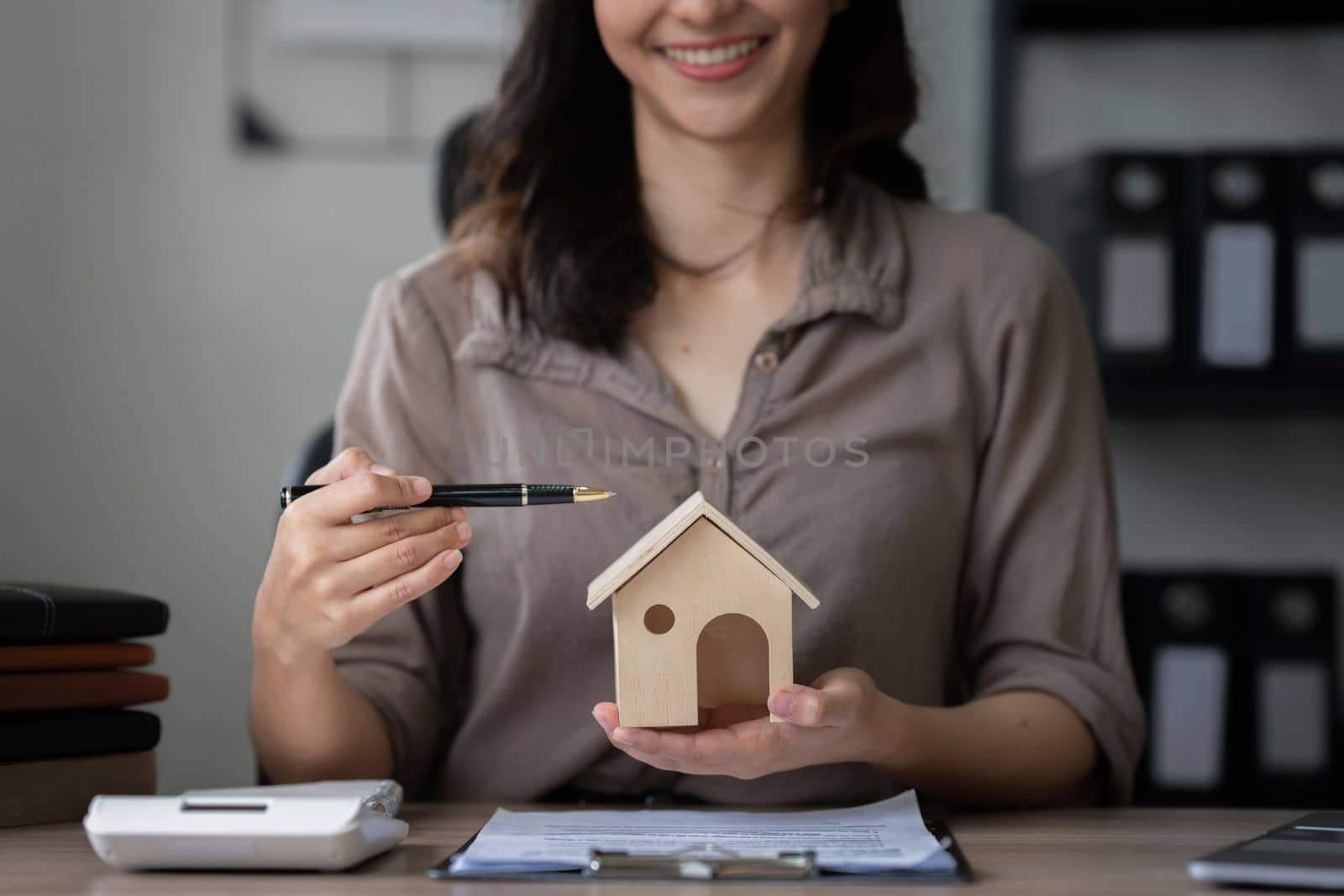 Real estate agent and customer discussing for contract to buy house, insurance or loan real estate background.