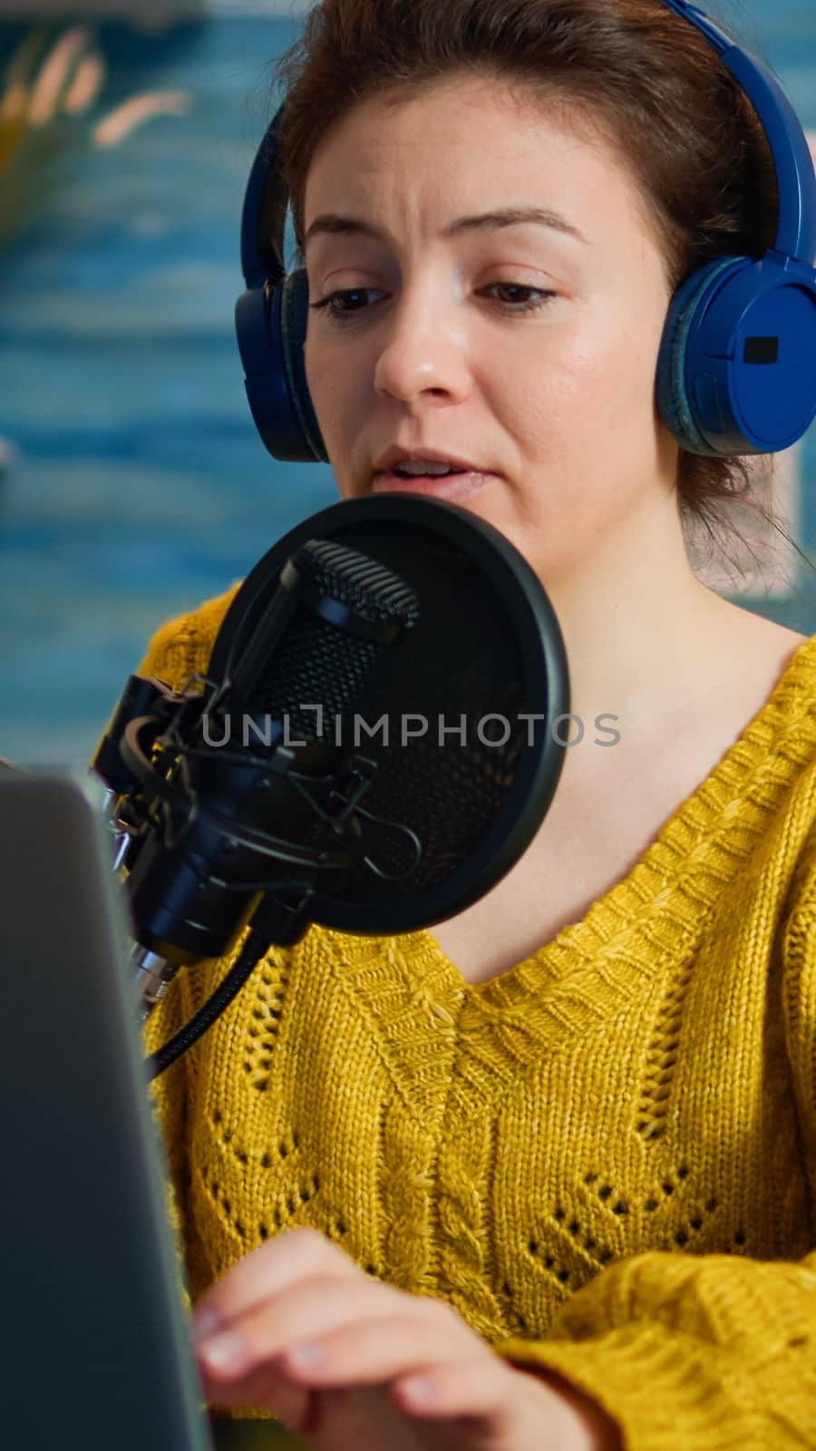 Vlogger looking at laptop while asking audience to subscribe on her channel. Creative online show On-air production internet broadcast host streaming live content, recording digital social media communication