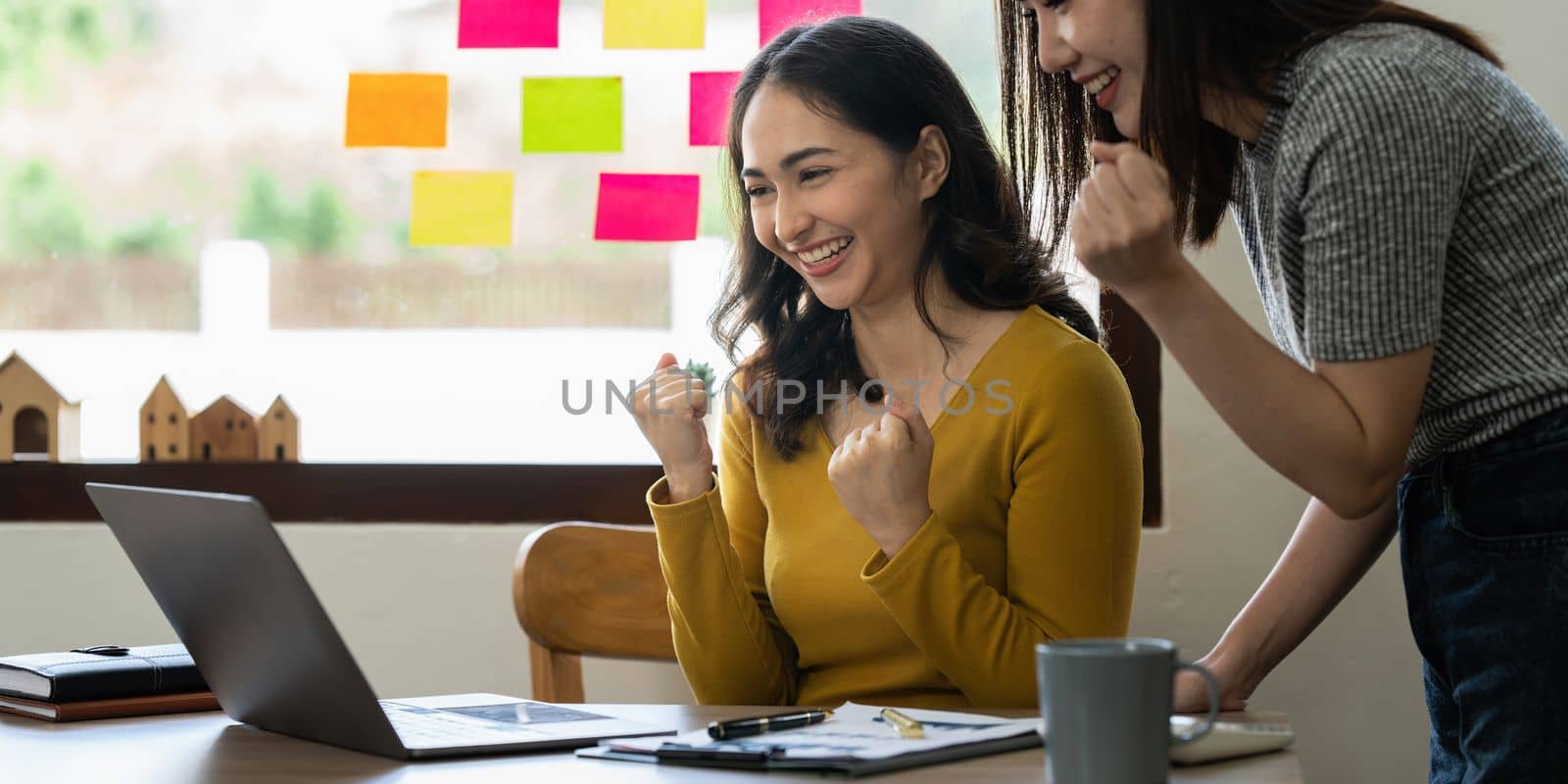 Smiling Businesswoman working with partner at office. finance concept by itchaznong