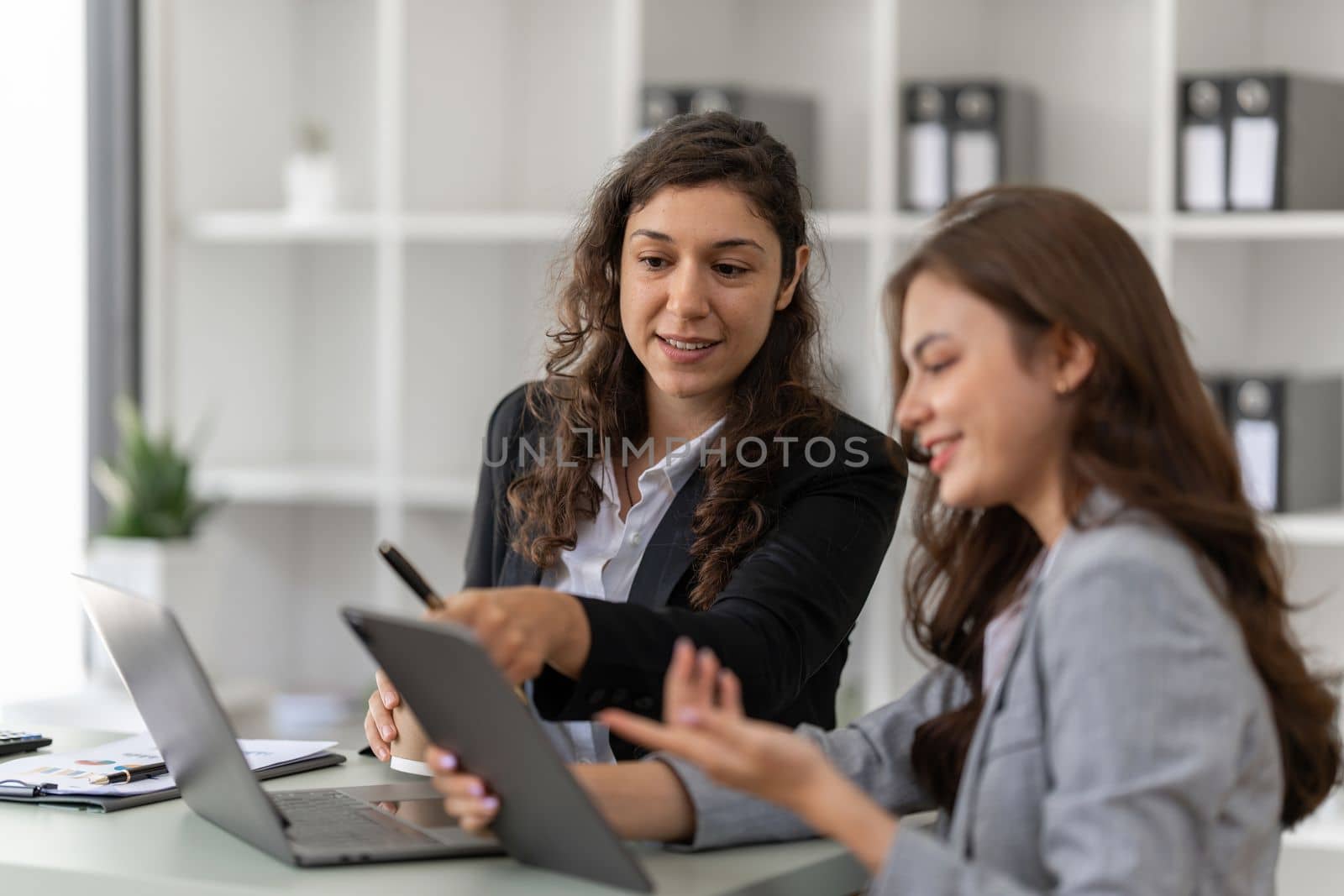 Fund managers team consultation and discuss about analysis Investment stock market by digital tablet.