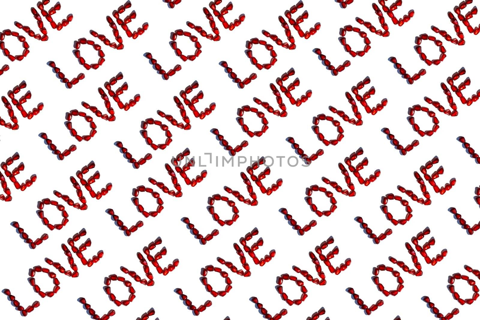 Love word from red pomegranate seeds. Valentine's day concept. Sign pattern. Isolated on white background