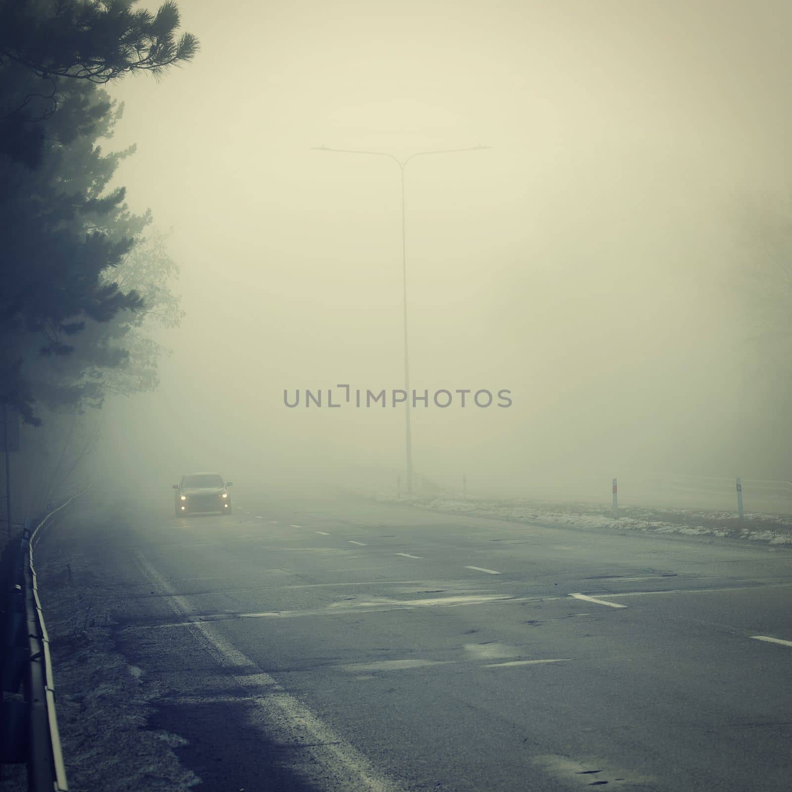 Bad weather driving - foggy hazy country road. Motorway - road traffic. Winter time. by Montypeter