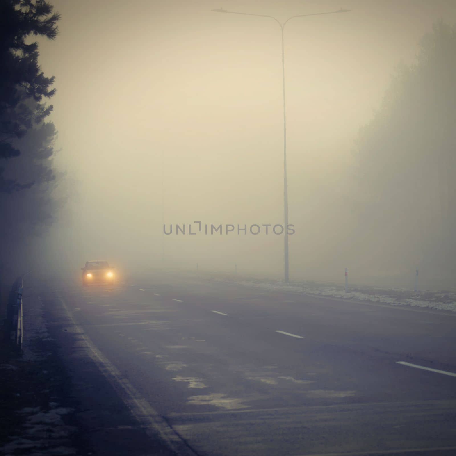 Bad weather driving - foggy hazy country road. Motorway - road traffic. Winter time. by Montypeter