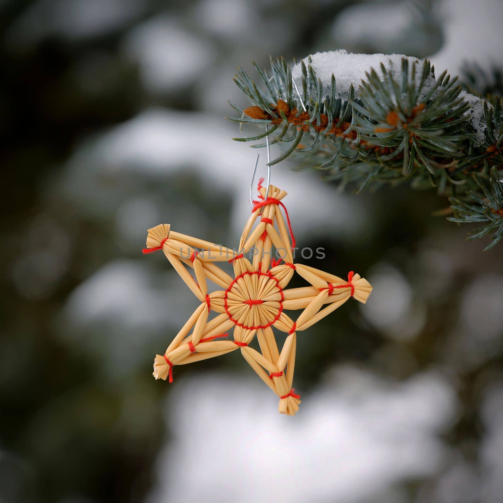 Christmas background with tree and natural old straw decoration. Winter holiday time with snow.