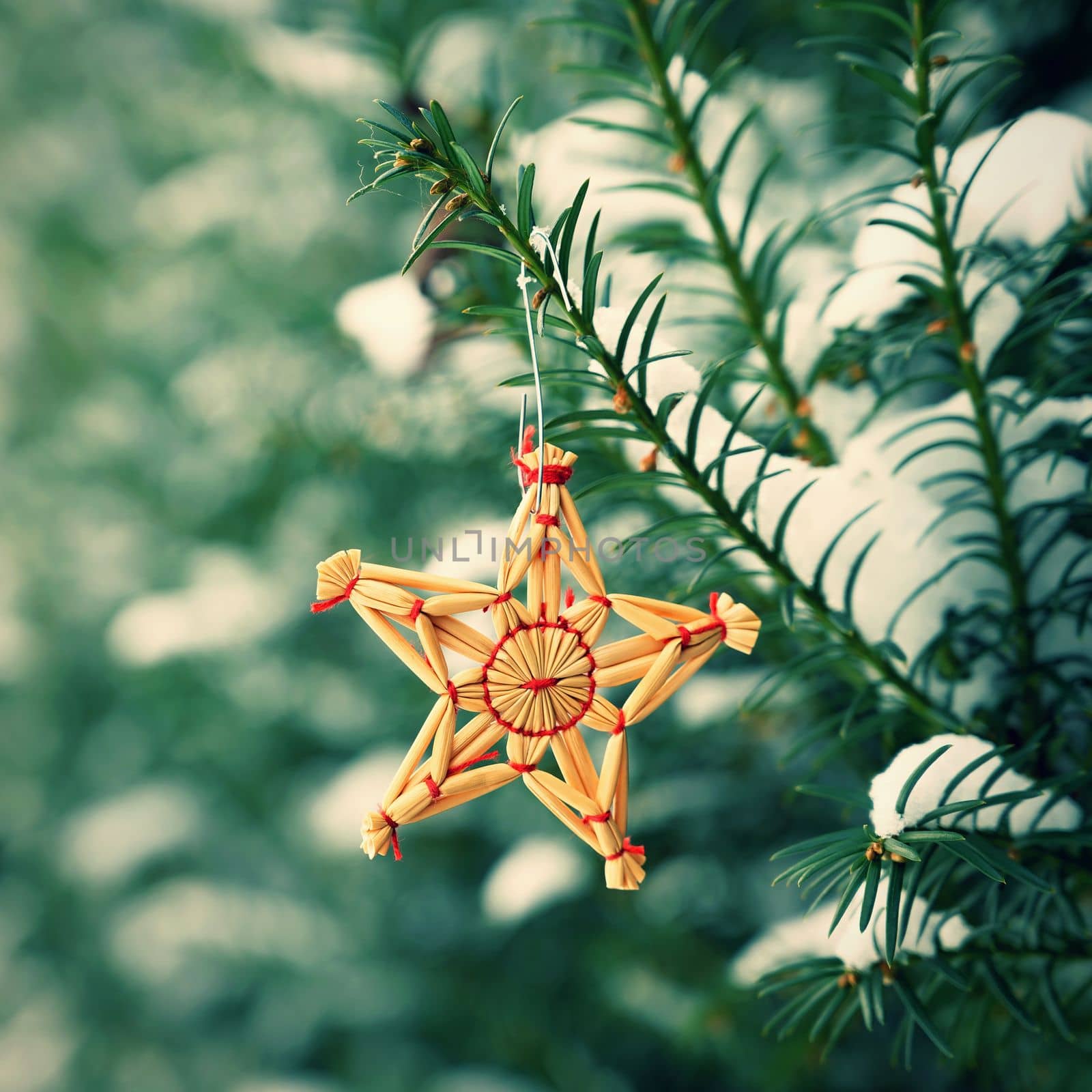 Christmas background with tree and natural old straw decoration. Winter holiday time with snow. by Montypeter