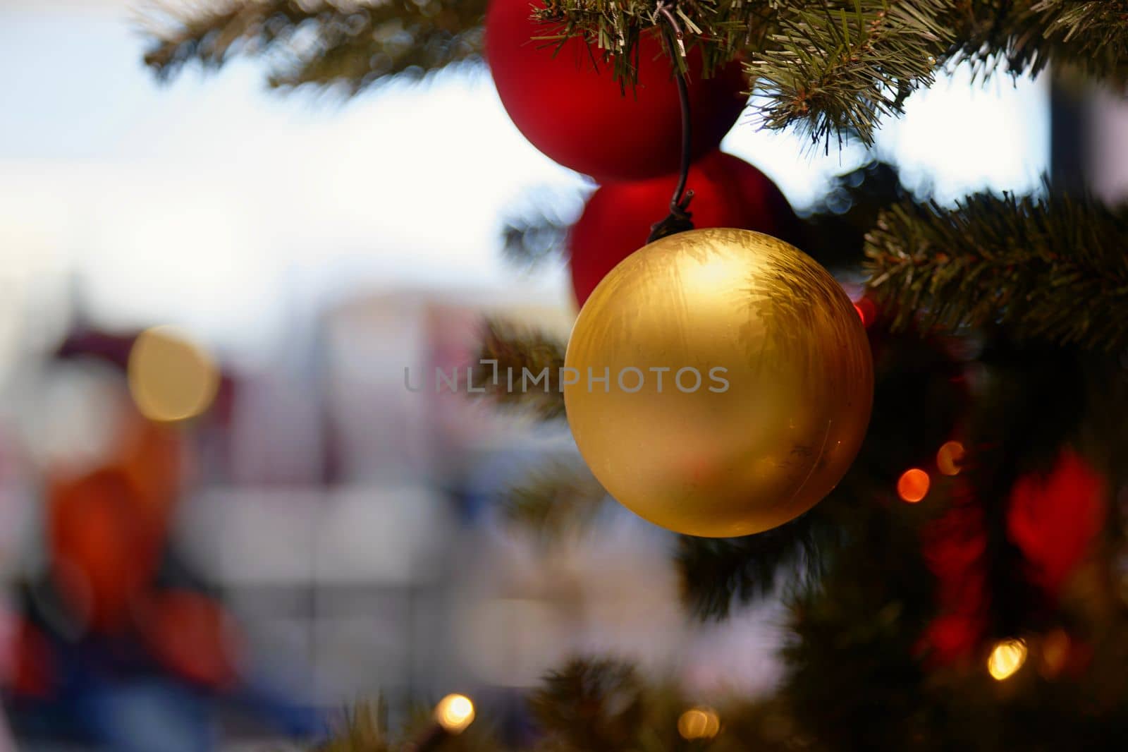 Ornaments and lights on the decorated Christmas tree. 
Christmas decorations on the holiday. Colorful balls garland glowing lamps and red berries on the branches are sprinkled with snow.Festive traditional seamless background for the New Year