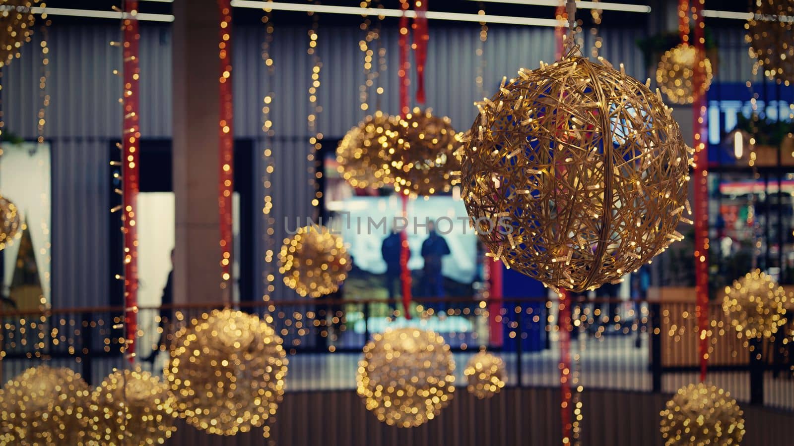 Ornaments and lights on the decorated Christmas tree. 
Christmas decorations on the holiday. Colorful balls garland glowing lamps and red berries on the branches are sprinkled with snow.Festive traditional seamless background for the New Year