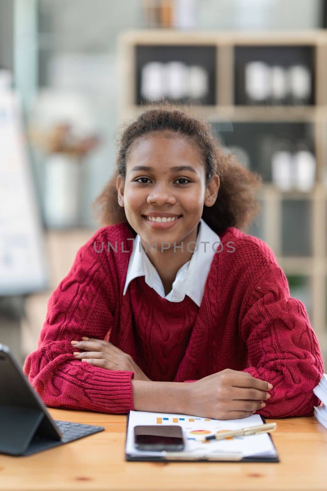 Portrait of beautiful young black woman using digital tablet