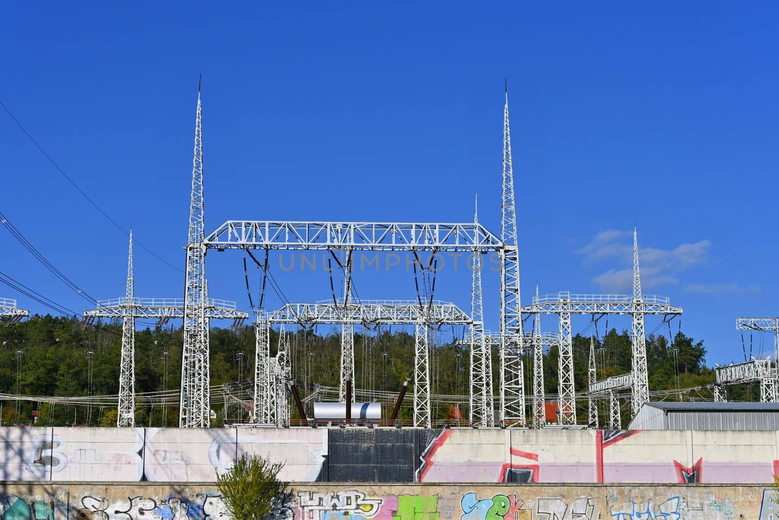 Power plant - electrical energy substation.- High voltage pylons. Concept for technology and industry. Rising energy prices - further rising electricity and energy prices - the energy crisis caused by the war between Russia and Ukraine.