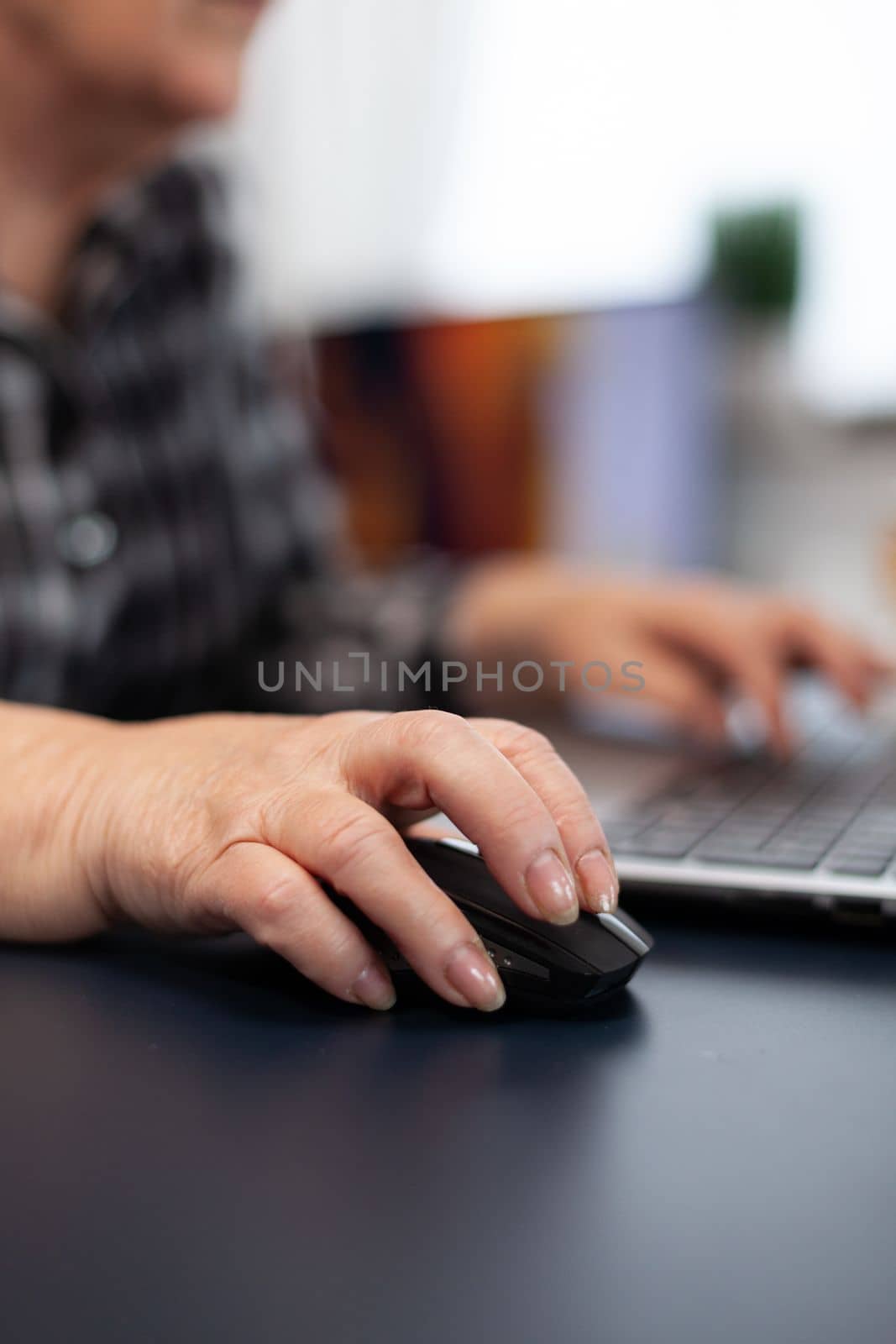 Close up of old entrepreneur lady using mouse by DCStudio