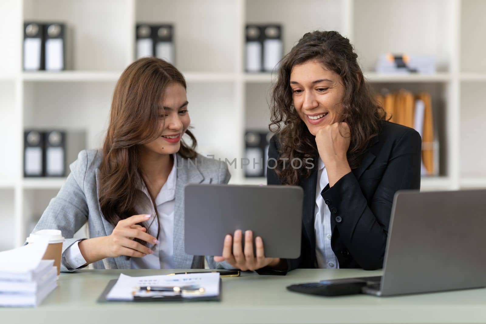 Fund managers team consultation and discuss about analysis Investment stock market by digital tablet.