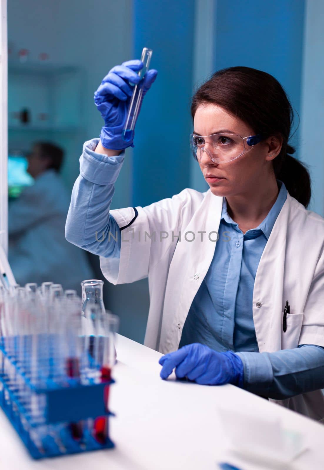 Scientist chemist analyzing a liquid sample and discovering genetic infection. Pharmaceutical biotechnologist in research laboratory works with test tube to find vaccine glove.