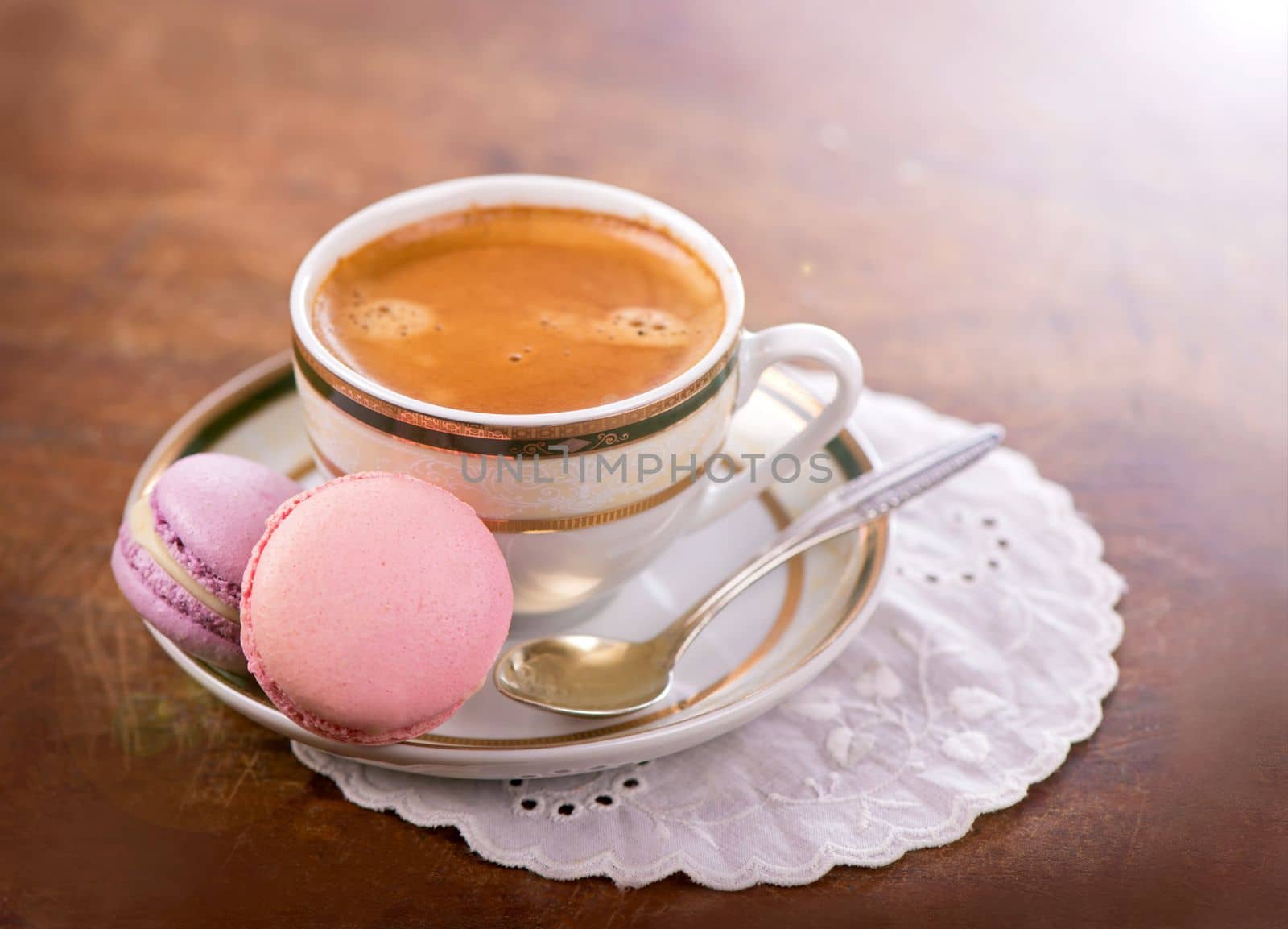 Macaroon with berries cookies and a cup of coffee on a wooden