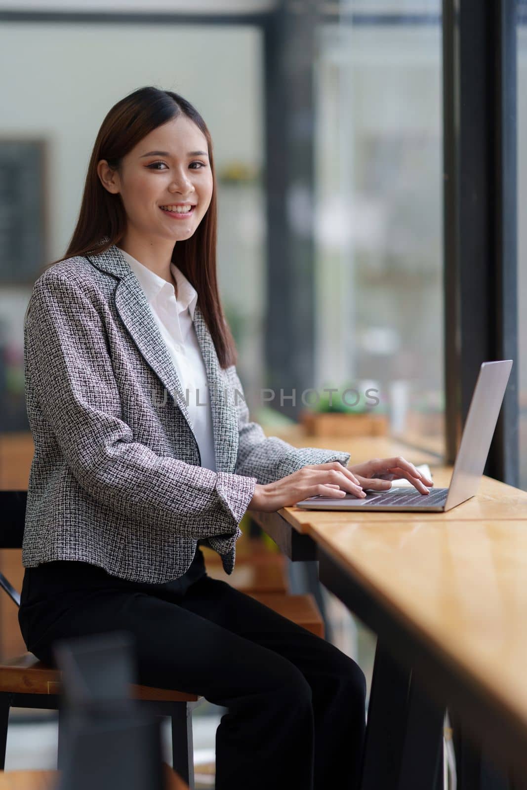 Asian Business woman working to analyze technical price graph and indicator with business team talking by cell phone. account or saving money or insurance concept.