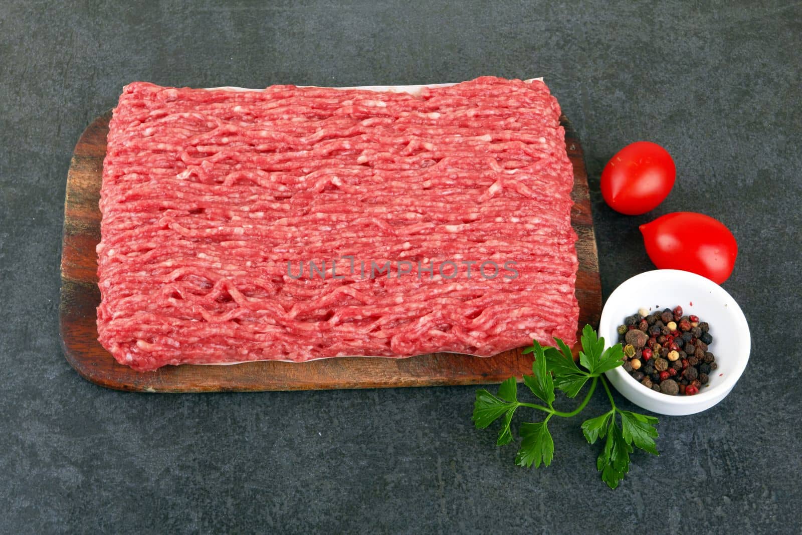 Fresh pork and beef minced meat on a black
