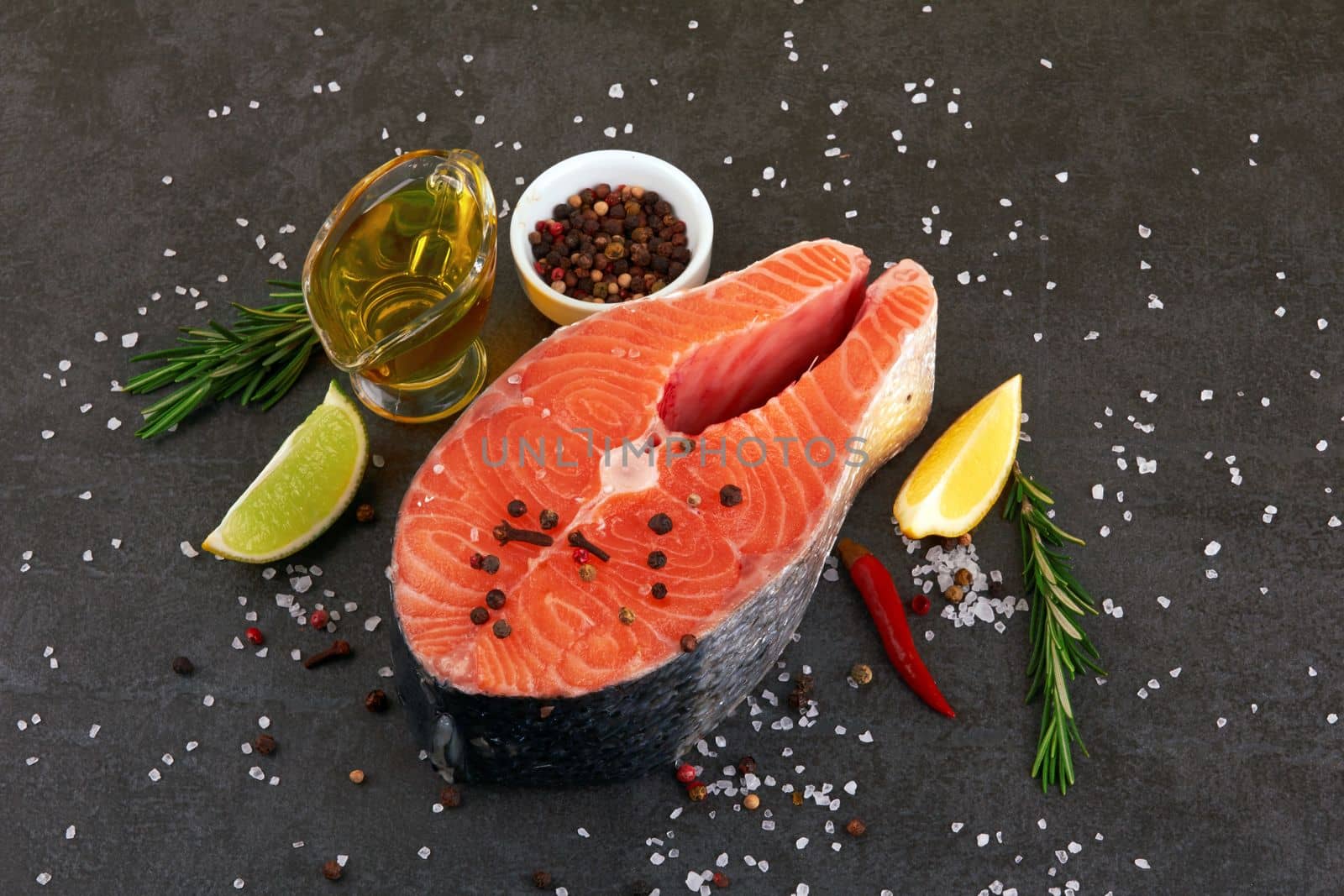 Salmon steak on a black background with spices