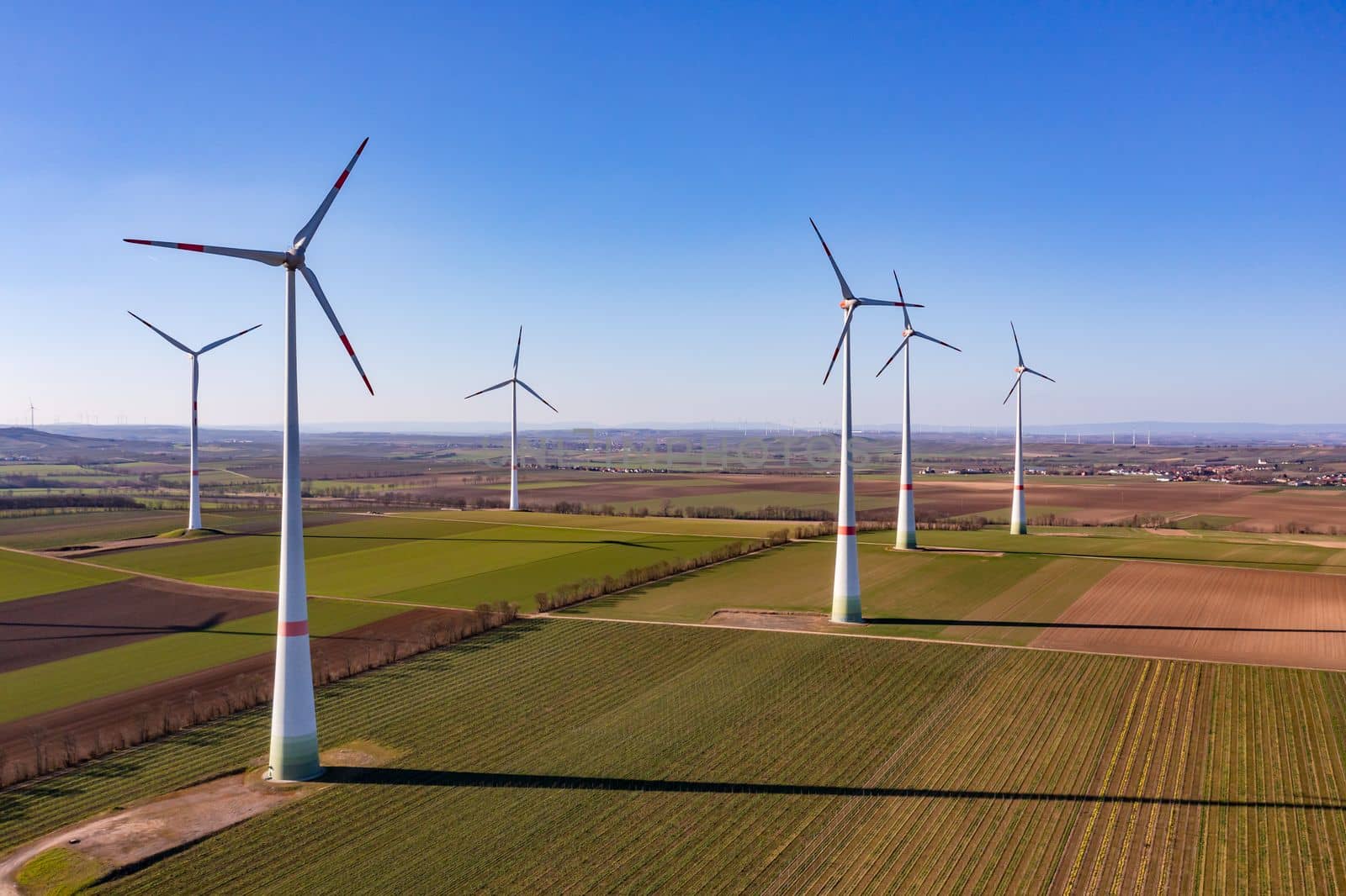 Wind turbines of a wind farm generate electricity for the energy transition as an aerial view, Germany