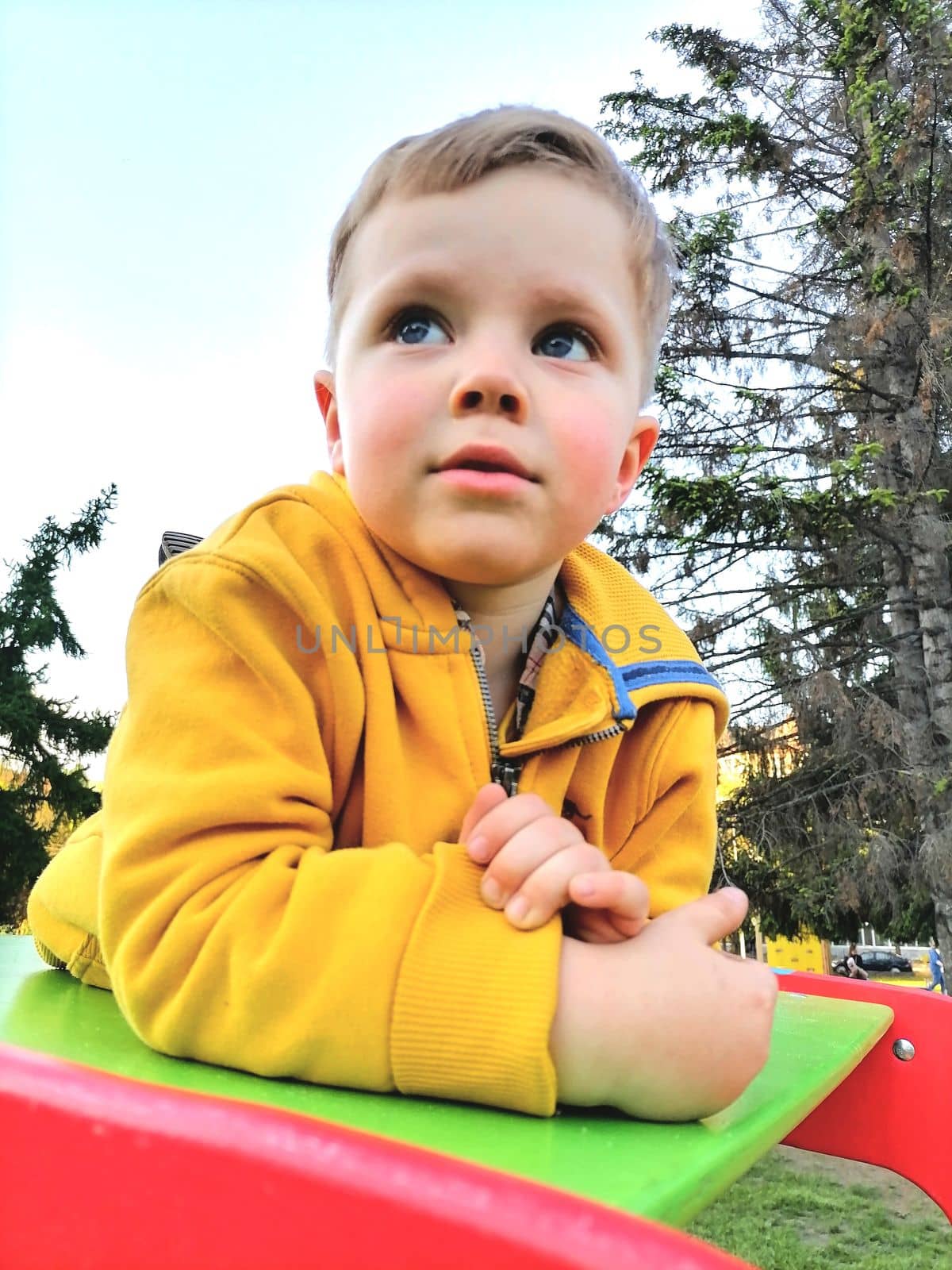 Adorable toddler boy having fun on playground by milastokerpro