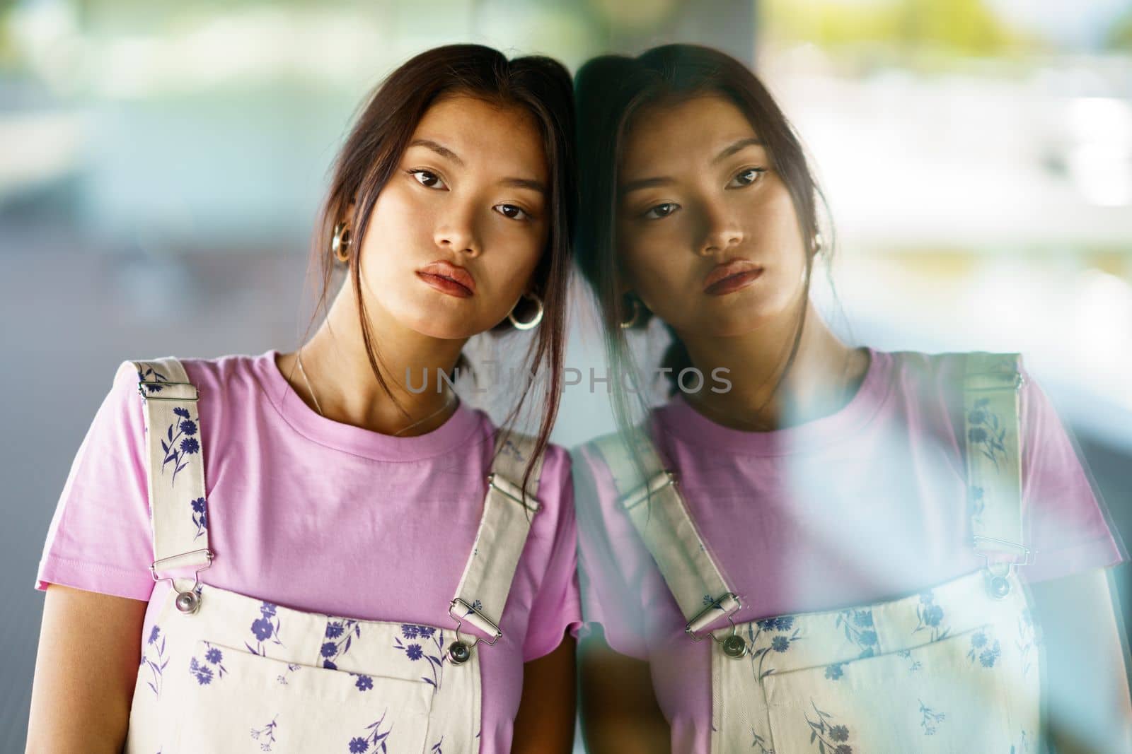 Thoughtful upset Asian woman lost in thoughts, pensive unhappy young female feeling lonely and depressed, thinking about relationship or personal problems.