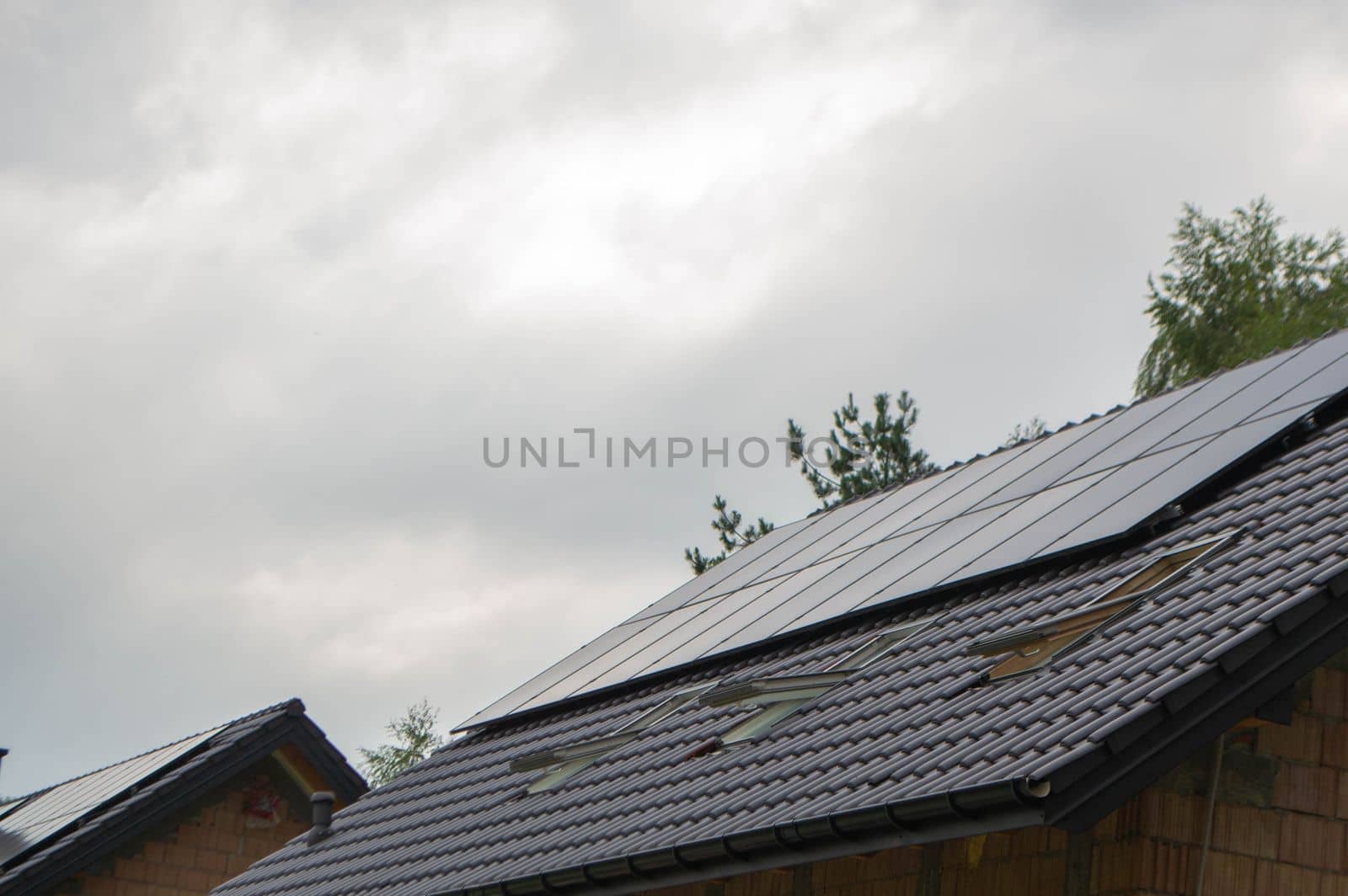 House roof with photovoltaic modules. Historic farm house with modern solar panels on roof and wall High quality photo