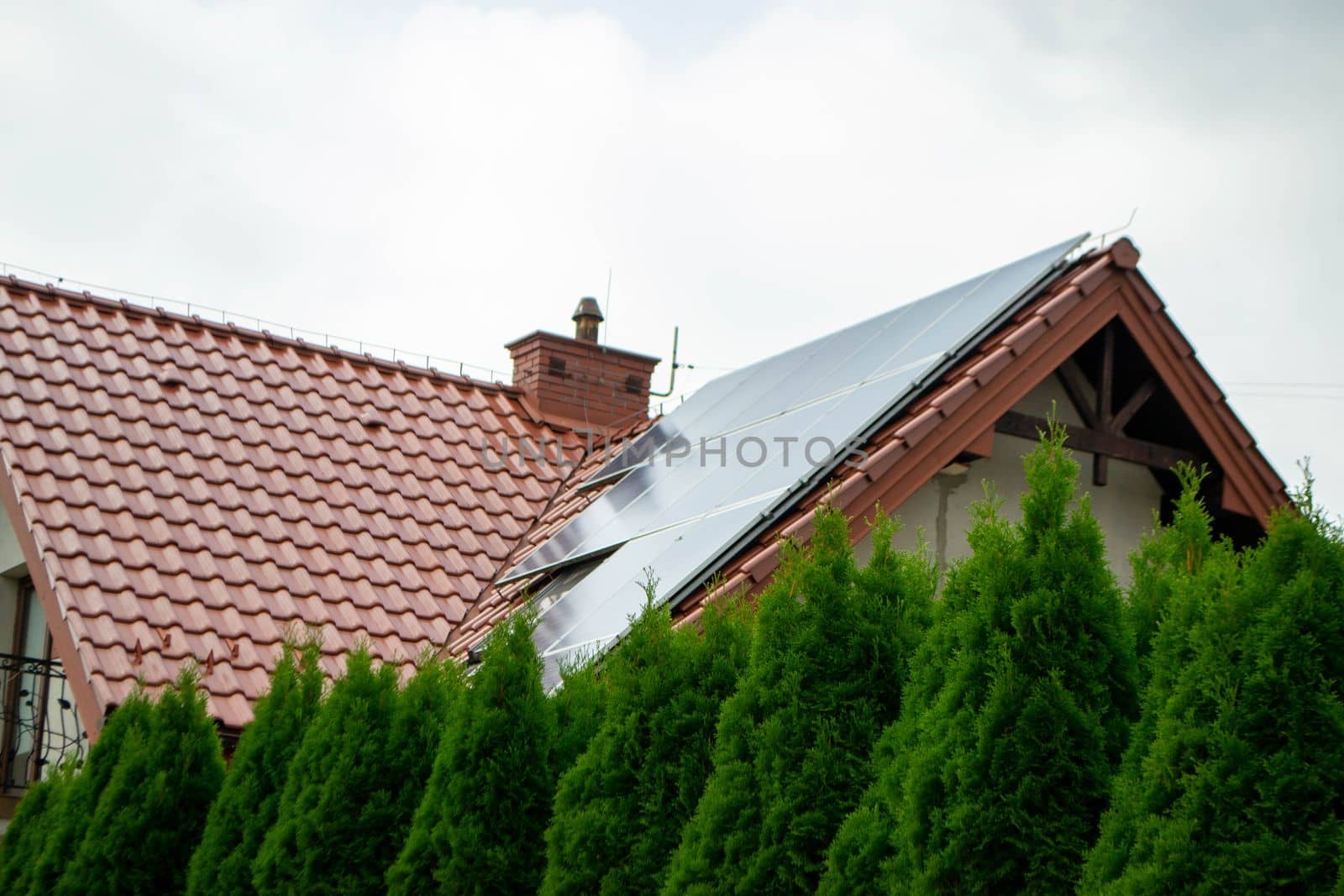 House roof with photovoltaic modules. Historic farm house with modern solar panels on roof and wall High quality photo