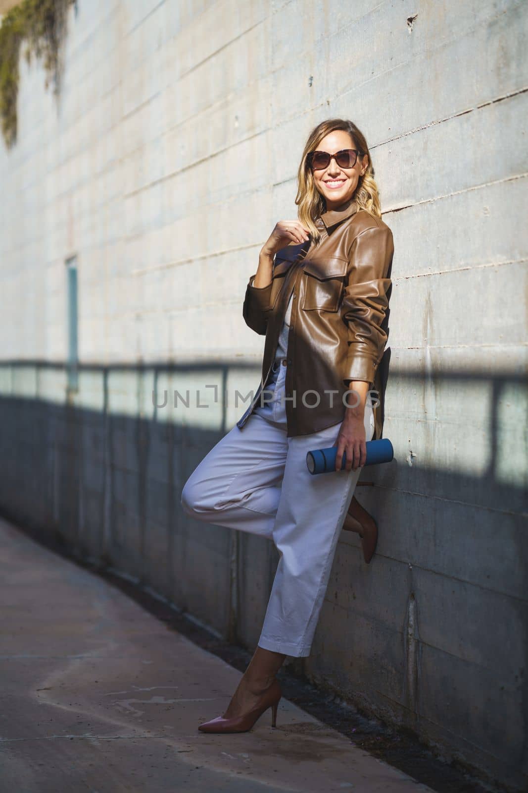 Middle aged woman with sunglasses taken a coffee break carrying an eco-friendly thermos for coffee by javiindy