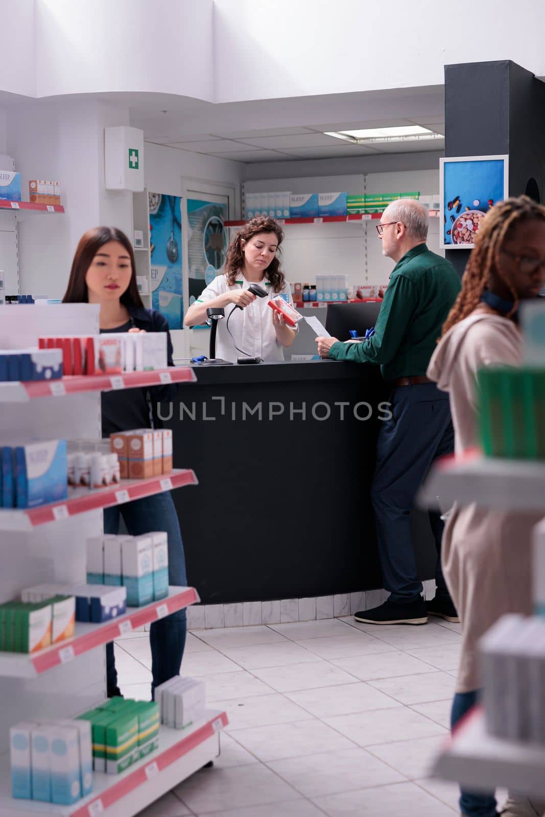 Senior customer standing at drugstore counter buying cardiology pills during medical consultation. Pharmacist helping client with supplements recommandation. Health care service support