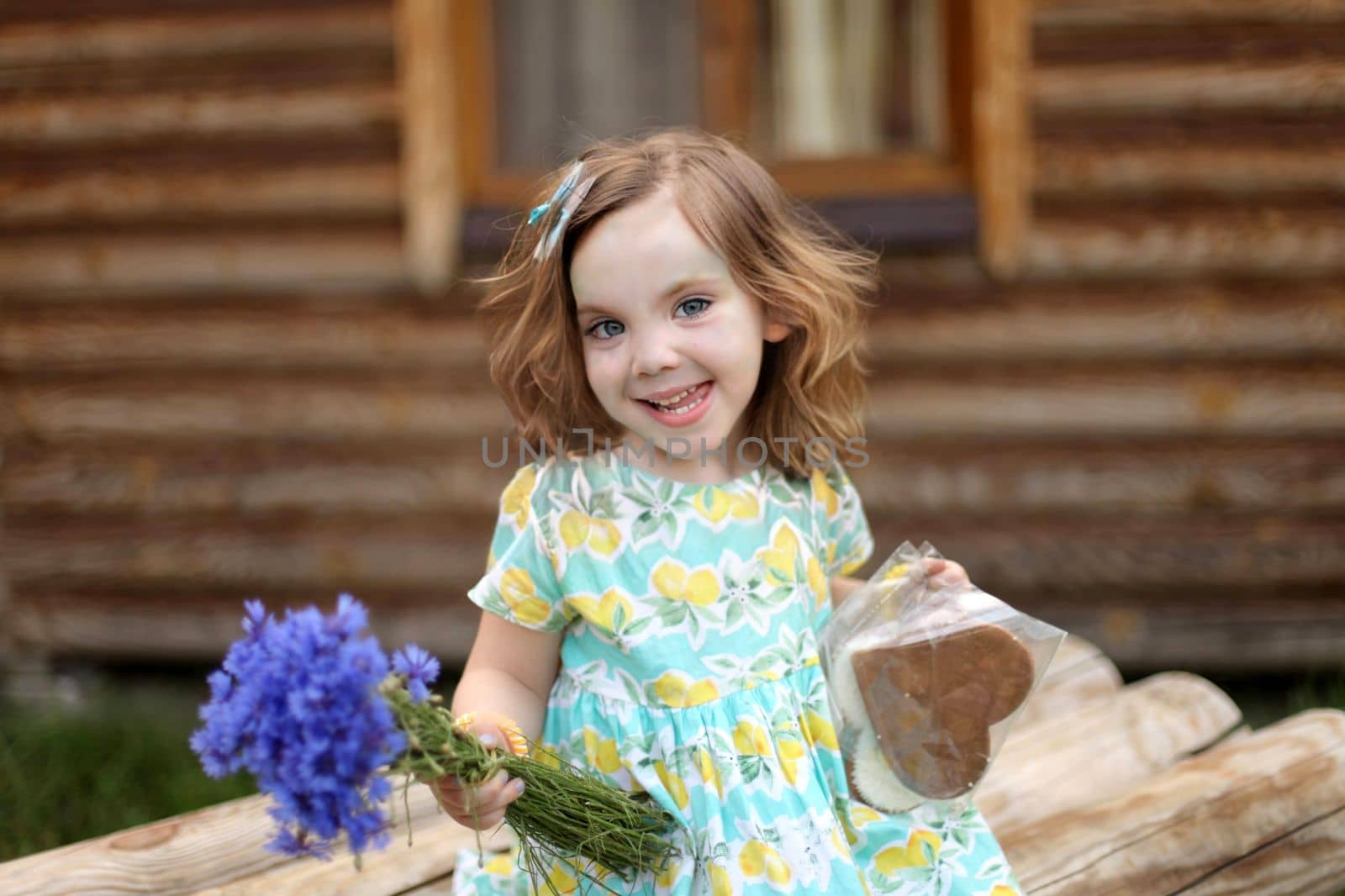 Cute little girl in autumn park holding bunch of yellow leaves. High quality photo