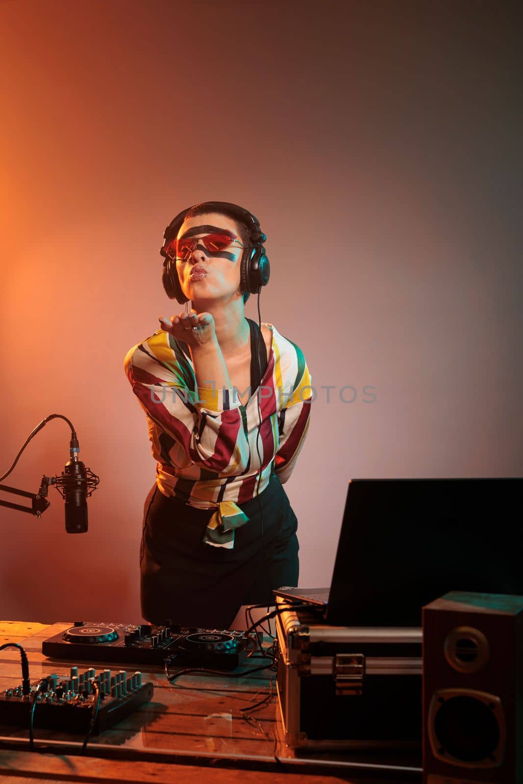 Female musician blowing air kisses in studio by DCStudio