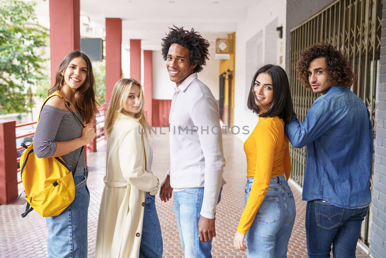 Group of beautiful friends of different ethnic having fun together in the street. by javiindy