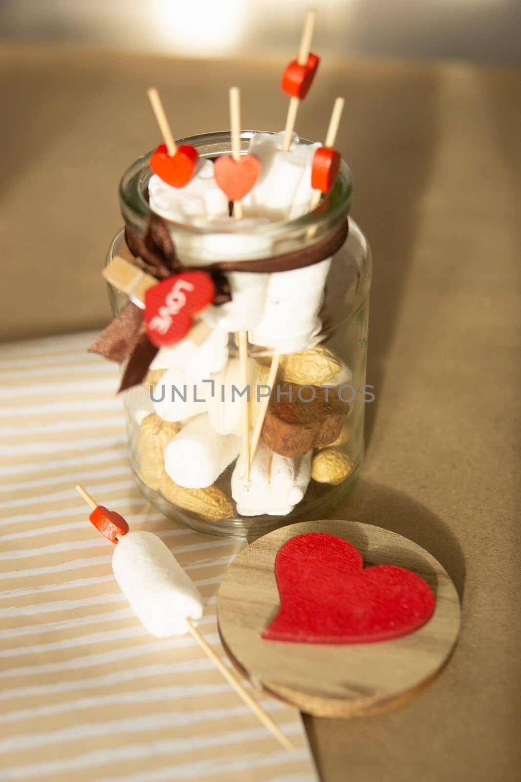 sweet gift for Valentine's Day with your own hands. A gift for the holiday made of heart-shaped candies and marshmallows.