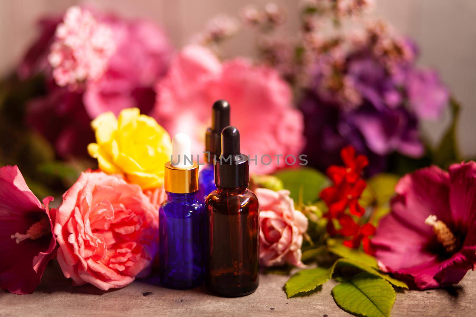 flowers and bottles of essential oils for aromatherapy by jp_chretien