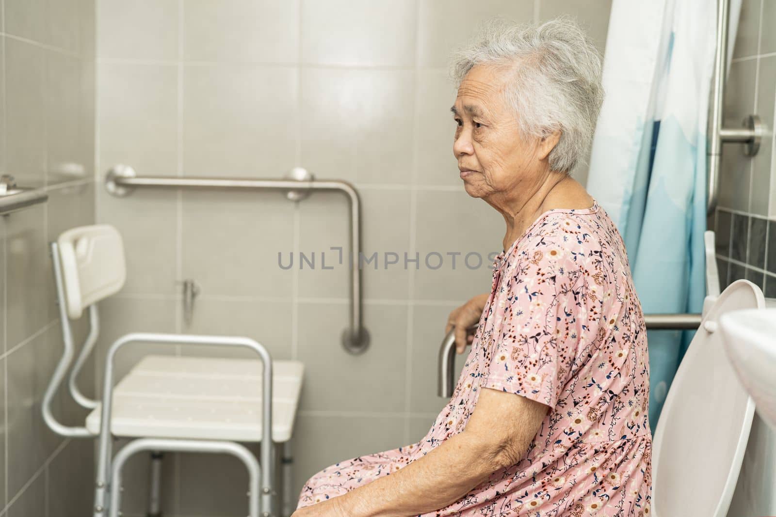 Asian senior or elderly old lady woman patient use toilet bathroom handle security in nursing hospital ward, healthy strong medical concept.